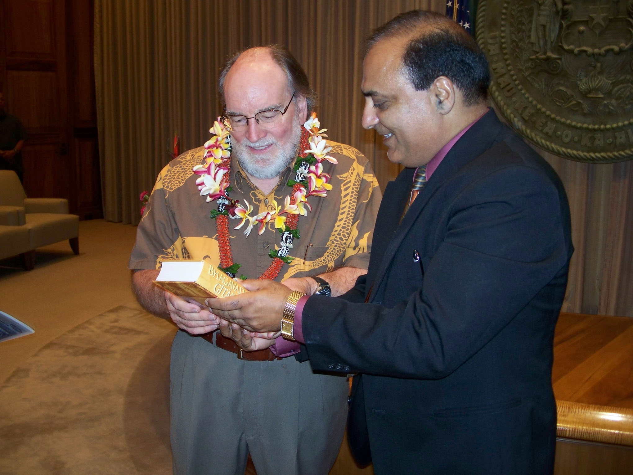 Dr. Raj Kumar with Governor Neil Abercrombie in 2012.