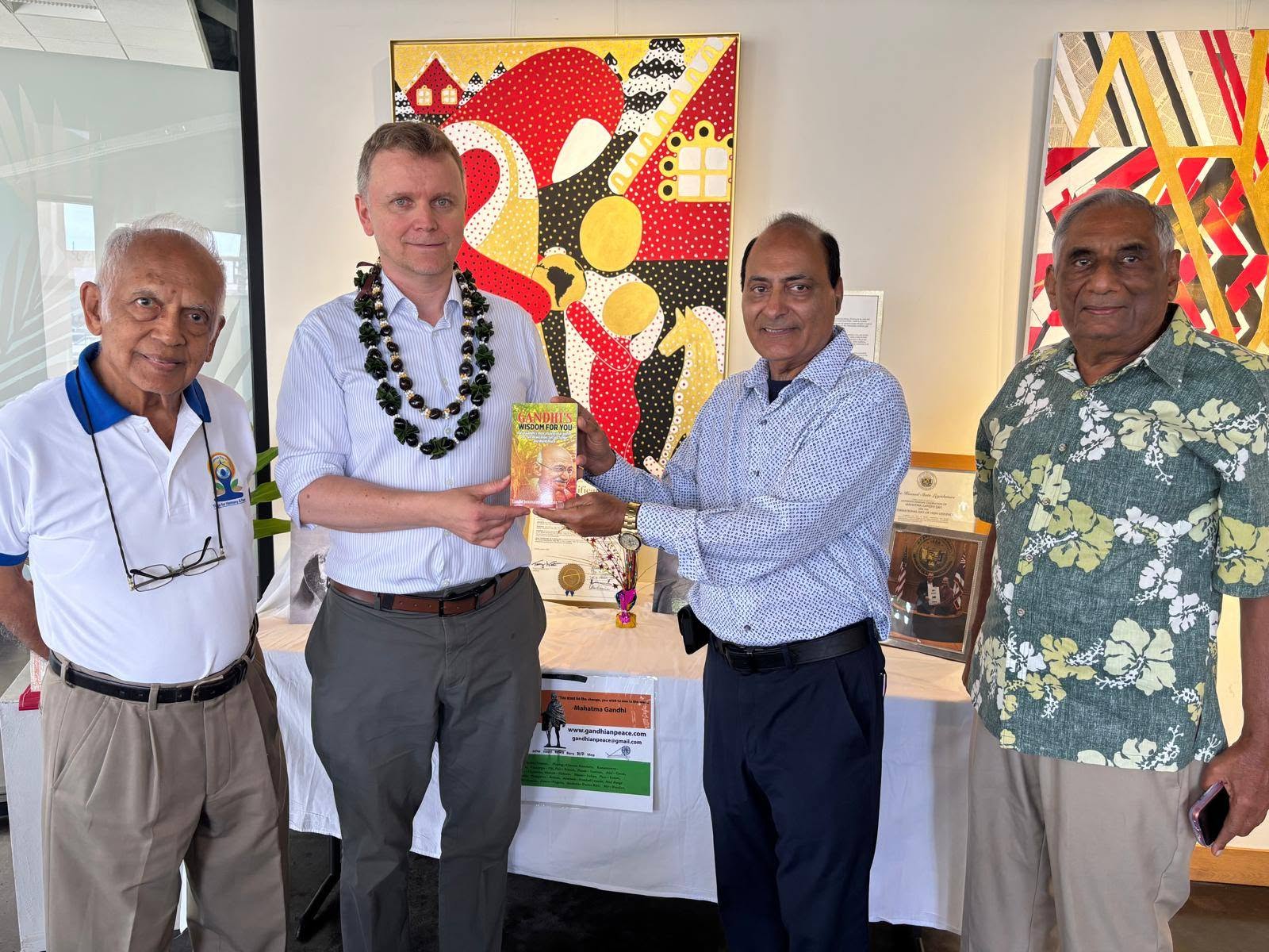 Paul Dziatkowiec receives a copy of Gandhi's Wisdom for You presented by GIIP representatives in Honolulu.